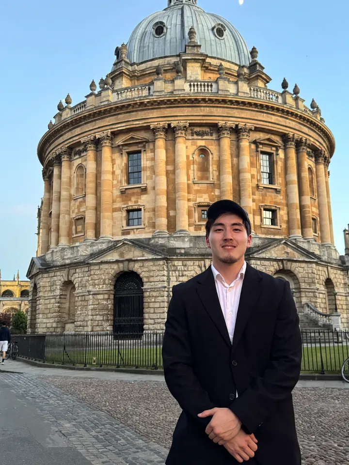 Khuselee outside historic Oxford stone architecture