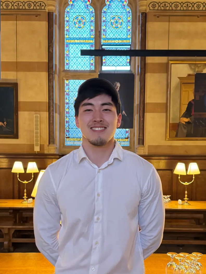 Khuselee in a formal college dining hall